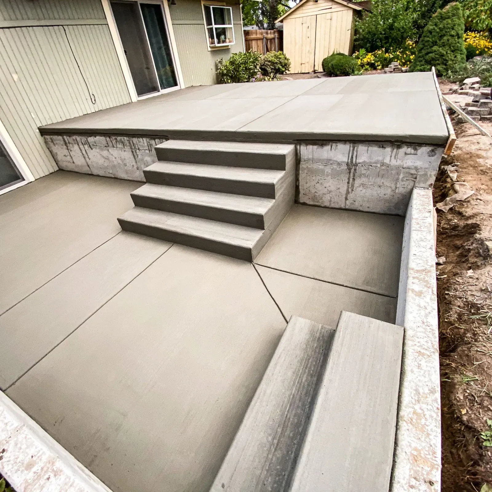 Freshly finished raised concrete patio with built-in steps