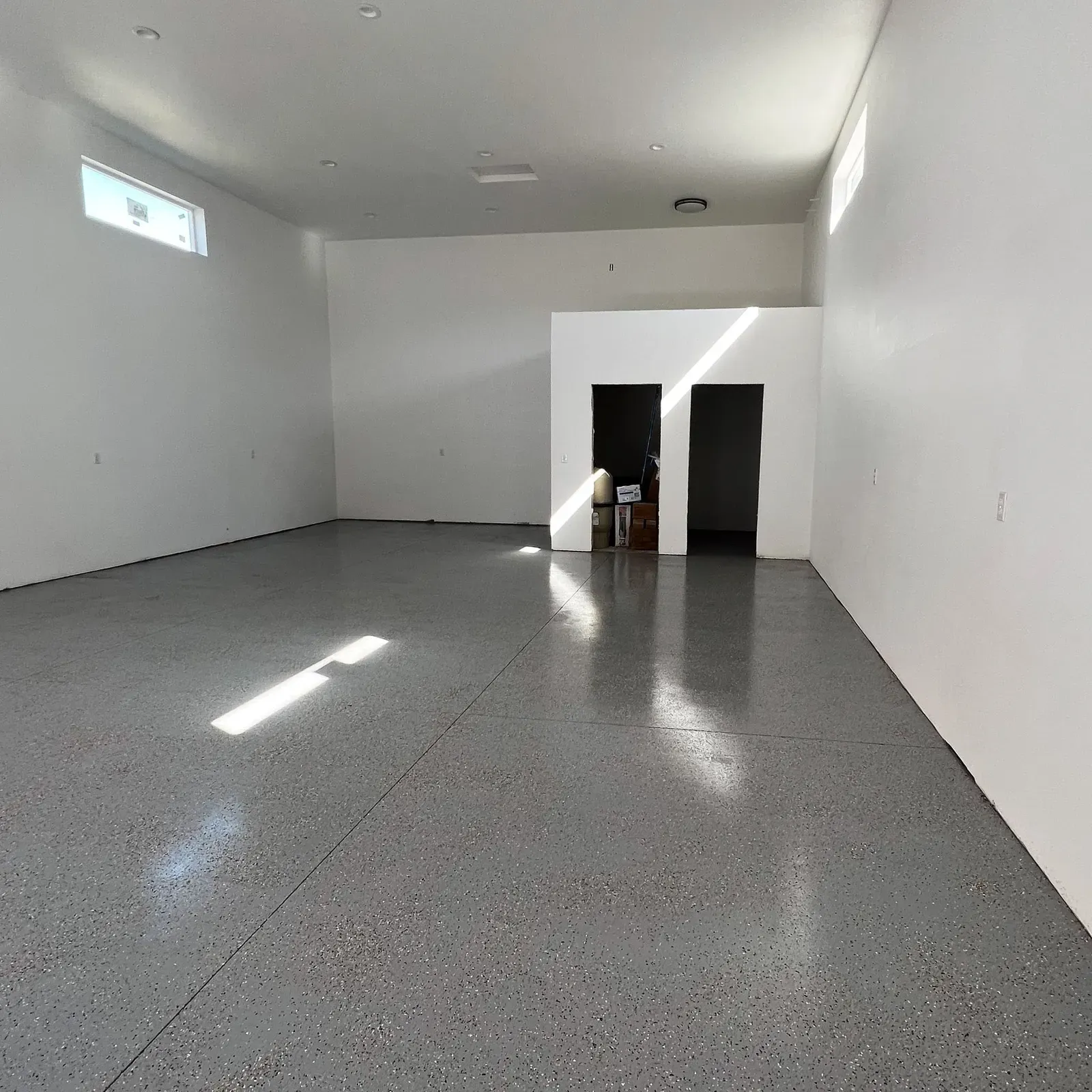 Commercial shop interior with a finished flake-coated concrete floor