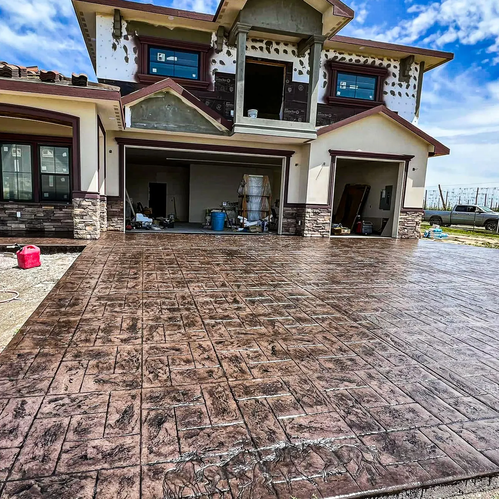 Large stamped concrete driveway in a stone pattern at a custom home