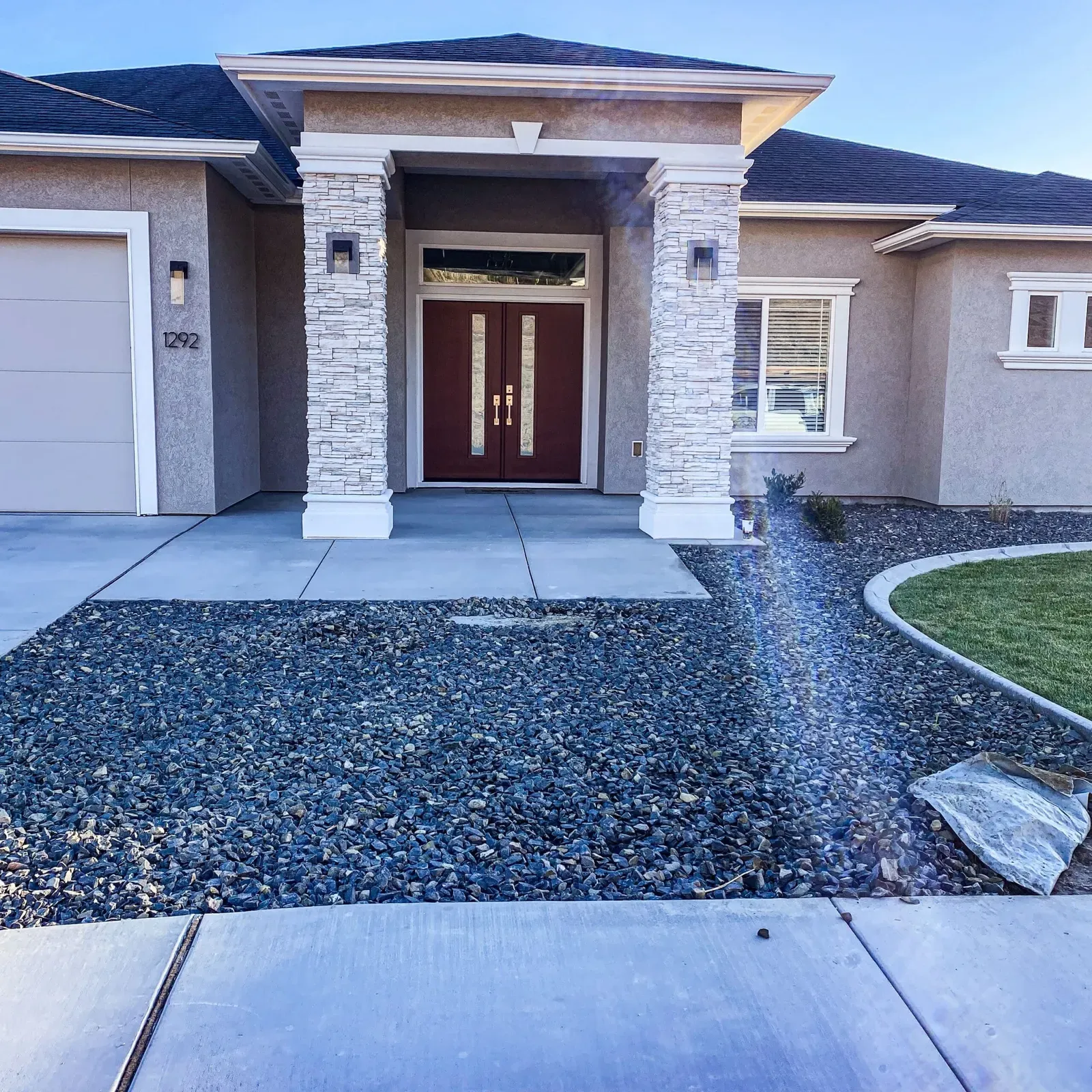 Clean new front walkway with fresh gravel landscaping