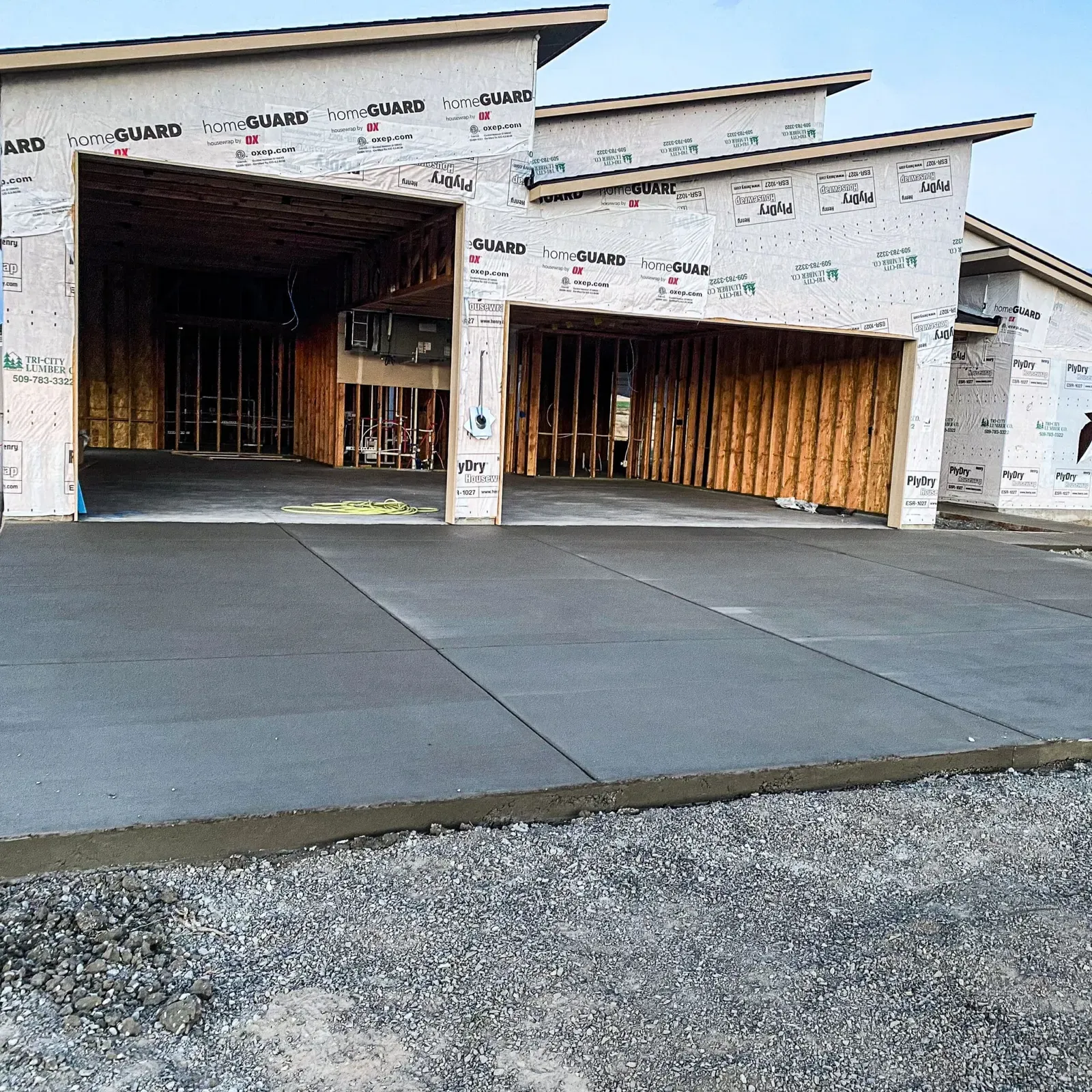 New garage slab and driveway approach at a home under construction