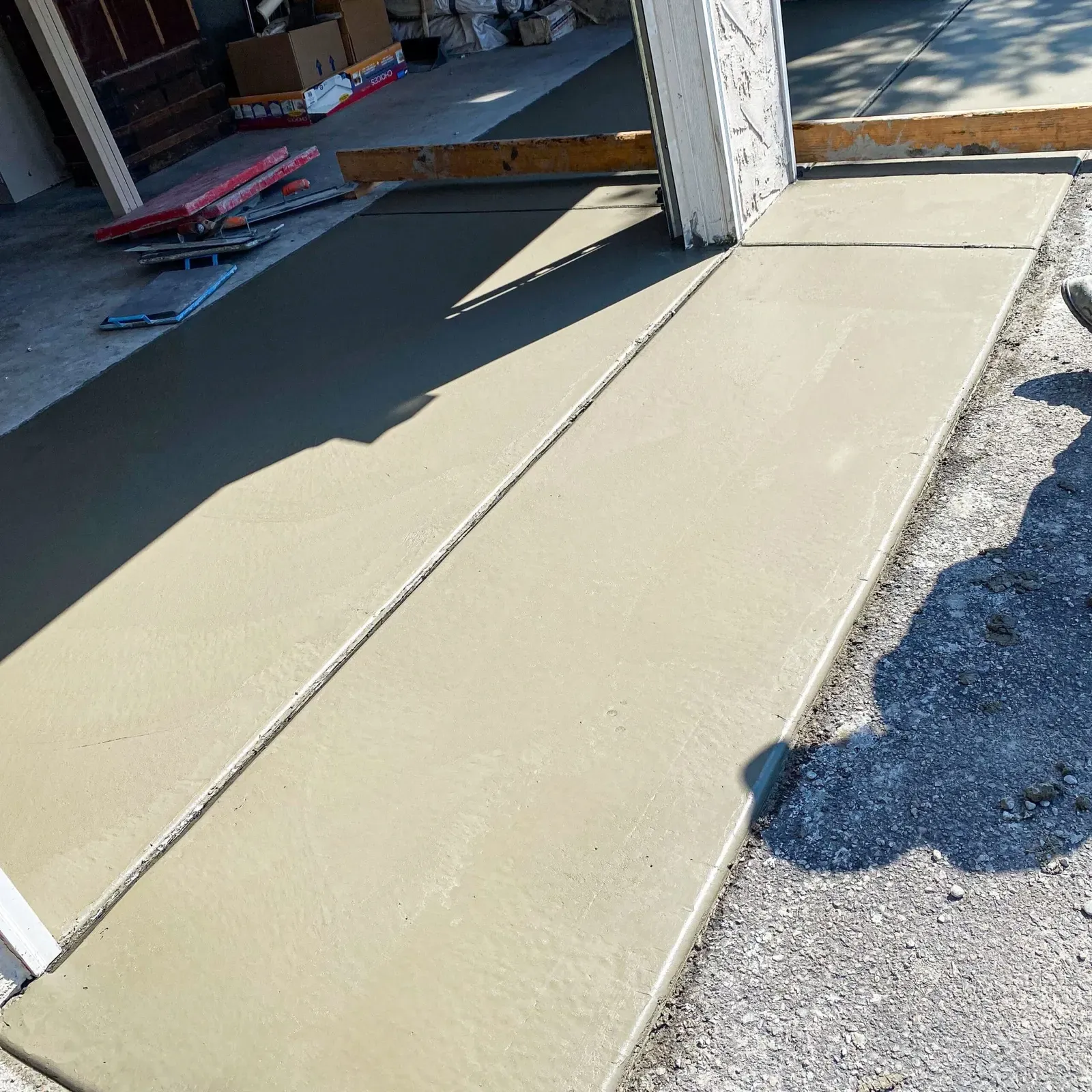 Fresh concrete sidewalk strip with clean troweled edges