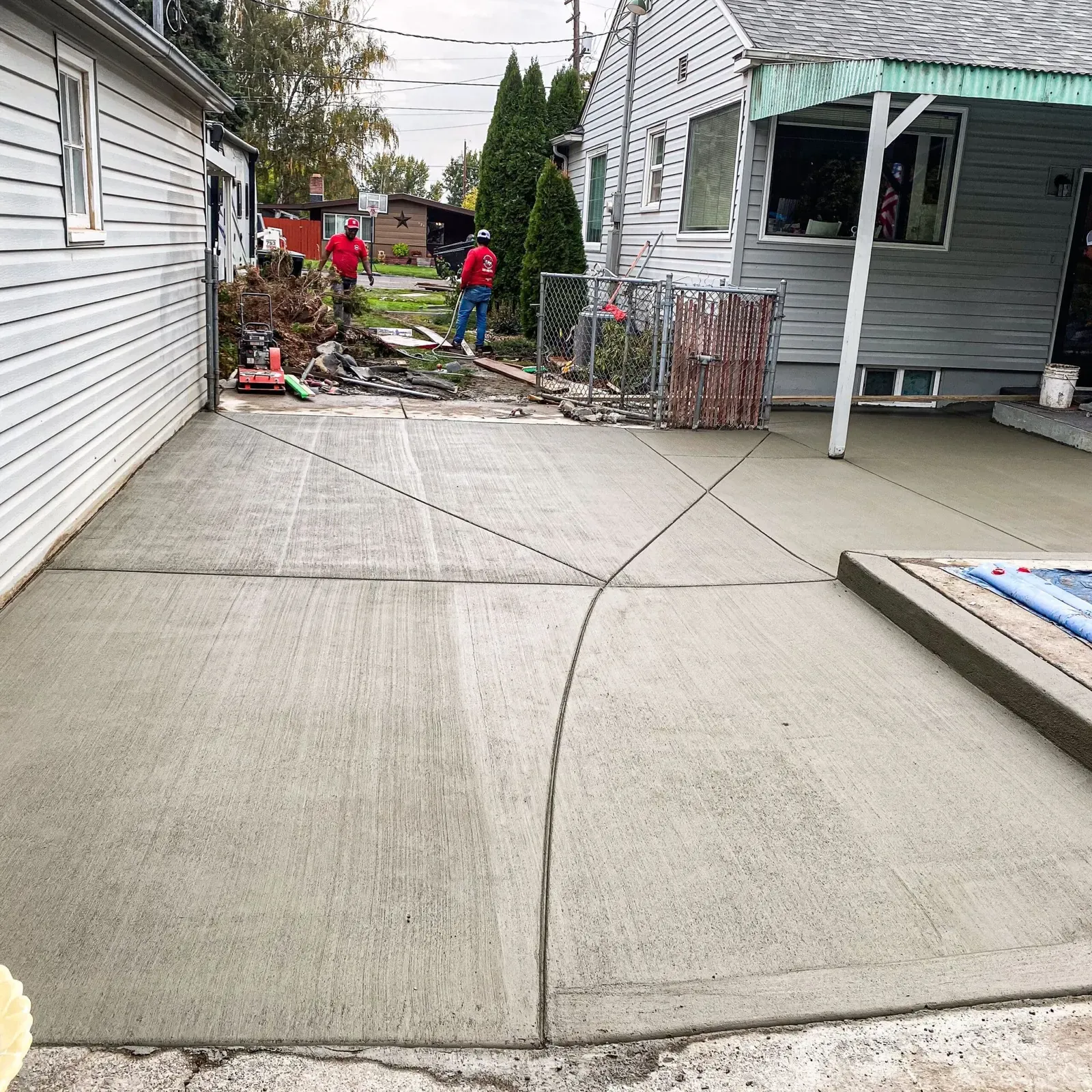 Large backyard patio with crisp control joints at a gray home